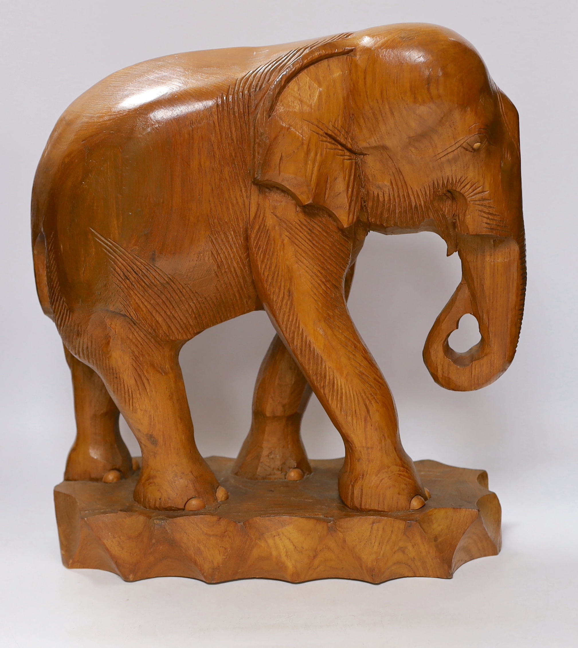 A pair of carved elephants, 42cm high
